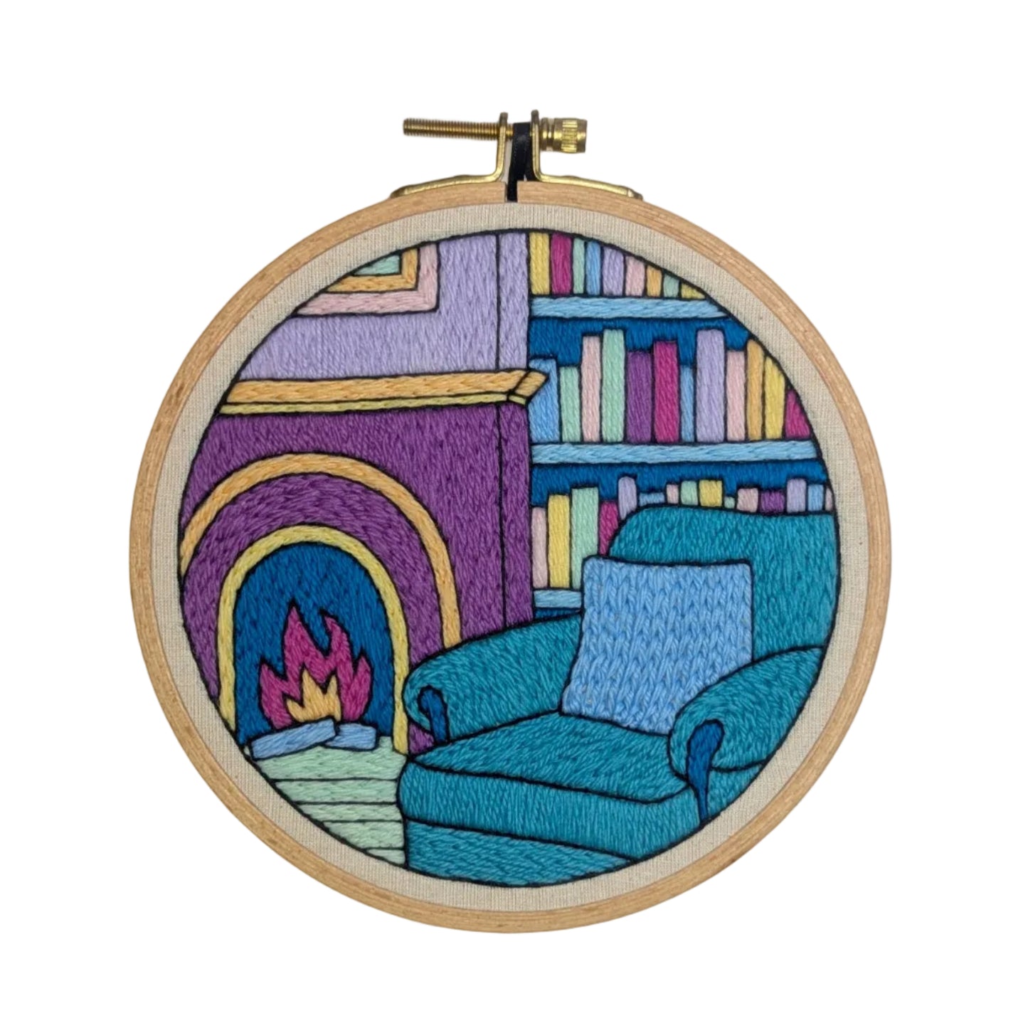 Embroidery hoop with a colorful depiction of a living room scene on a white background