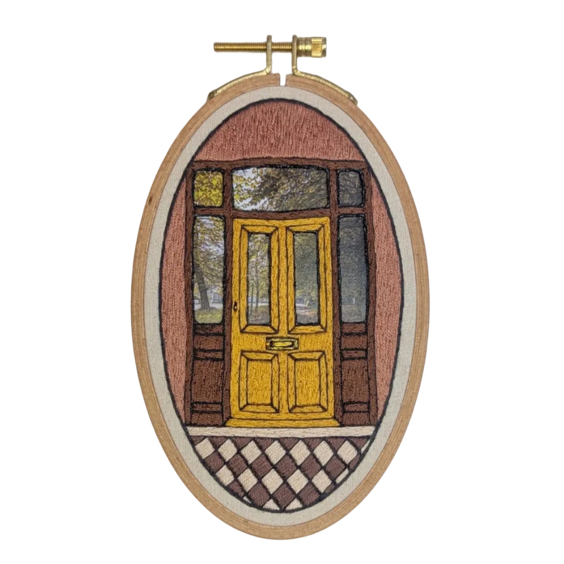 Embroidery of a yellow door in an oval frame on a white background